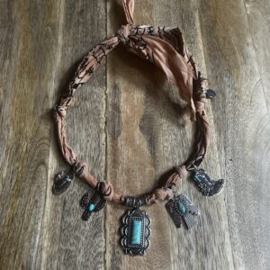 Charming Bandana in Faded Orange  -  Western-themed charms each with a turquoise color accent- Adjustable length
